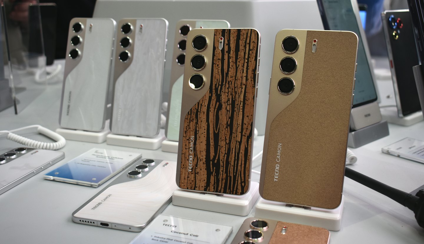 Tecno Camon smartphones with various finishes displayed on retail stands.
