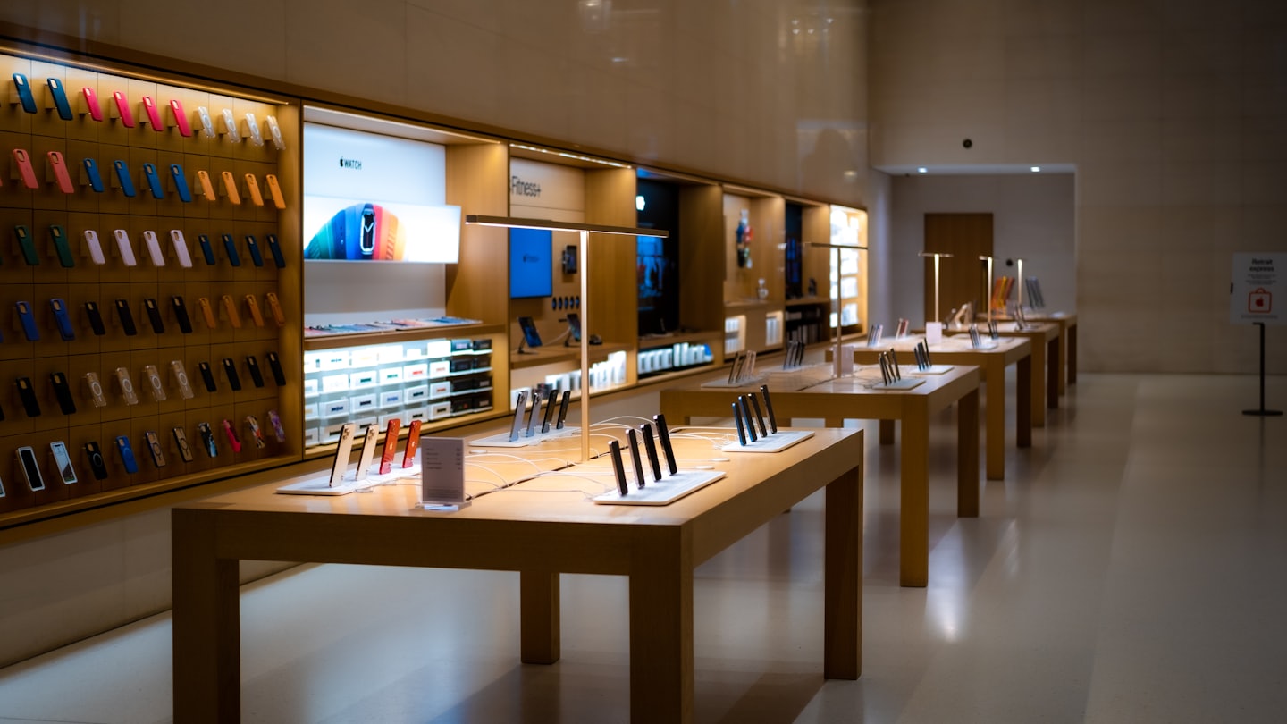 Modern electronics store with rows of mobile phones and accessories.